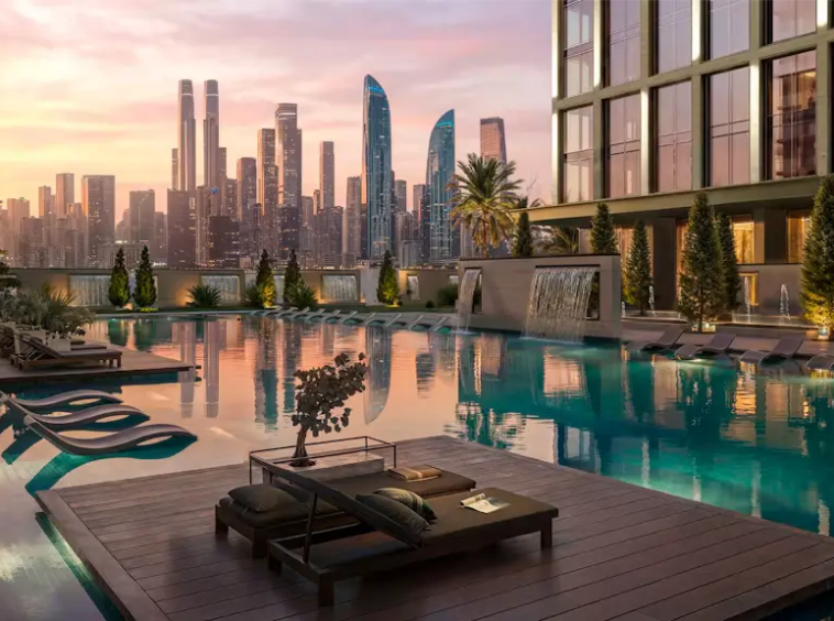 Luxury swimming pool and sun loungers at Binghatti Spectre overlooking the Dubai skyline at sunset